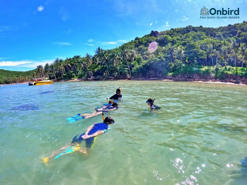 Kids playing in the shallow water meanwhile getting used to the snorkel gears