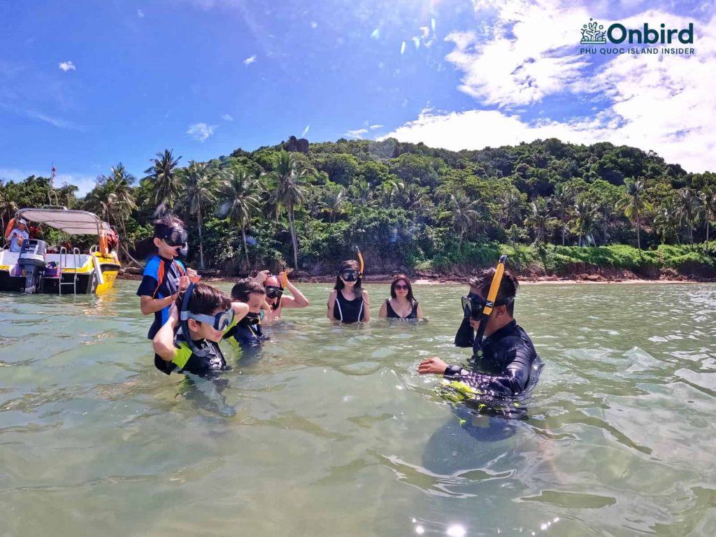 Kids playing in the shallow water meanwhile getting used to the snorkel gears