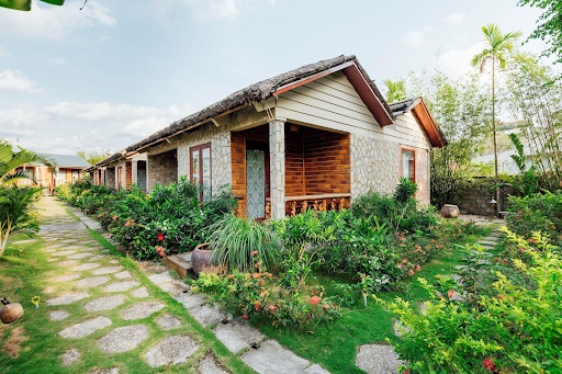 The Pathway Leading To The Bungalows Adorned With Flowers And Foliage