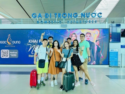 Enthusiastic young travelers at the domestic departure terminal, preparing for their flight to Phu Quoc.